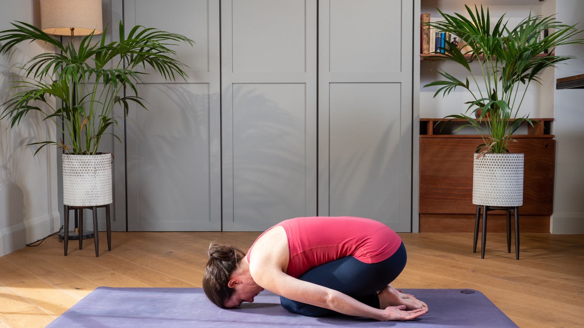 Woman holding a child's pose position
