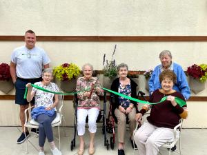 Plantpockets' managing partner and several residents of The Landing of Lake Worth are excited to welcome their vertical garden.