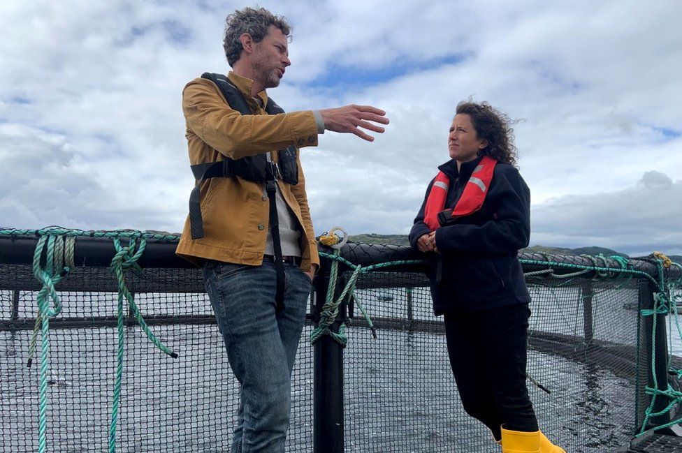 Andrew Cannon, of Kames Fish Farming, speak to Mairi Gougeon
