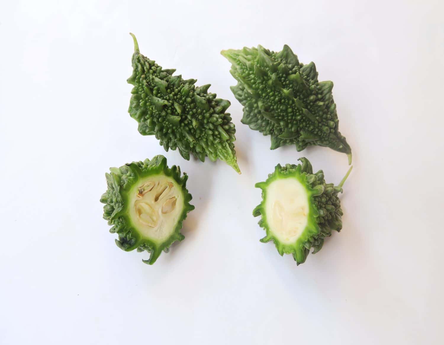Vegetable Bitter gourd in isolated background. Scientific name - Momordica charantia. It is widely grown in Asia, Africa, and the Caribbean for its edible fruit.