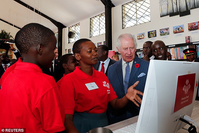 Britain's King Charles meets secondary school pupils during his visit to the library