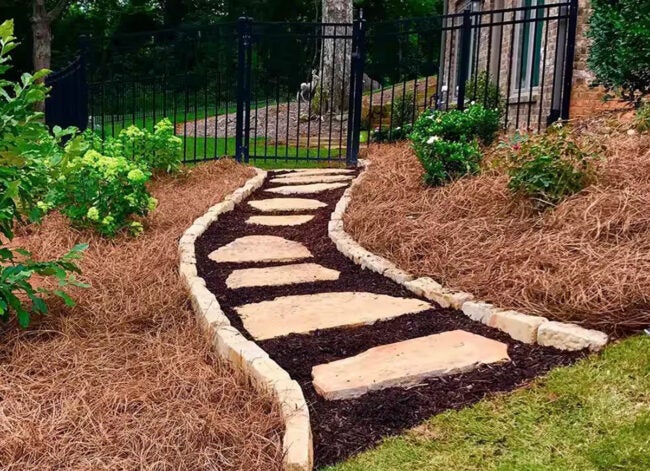 A home landscape with flower beds mulched with pine straw mulch.
