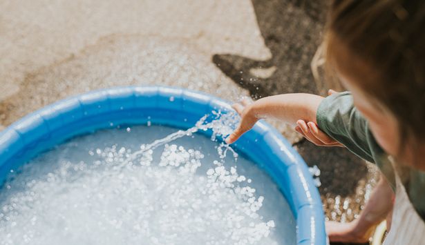 A little girl with a paddling pool